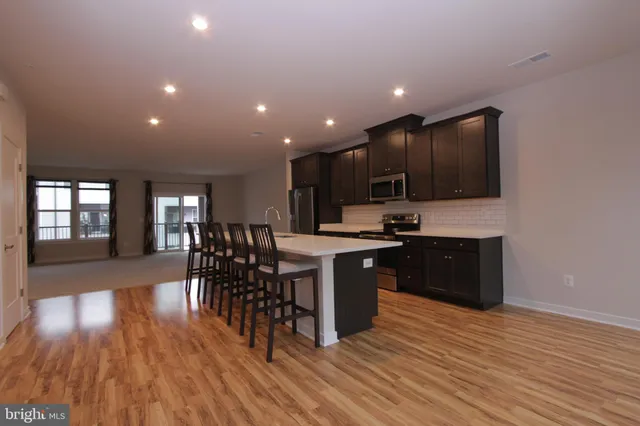 a kitchen with a sink appliances and cabinets