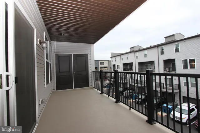 an empty room with a window and a ceiling fan