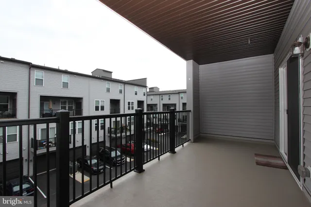 an empty room with a ceiling fan and entryway
