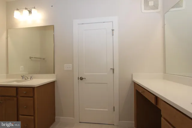 a view of a hallway with closet and wooden floor