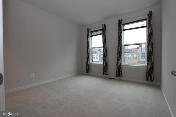 a large kitchen with stainless steel appliances a large counter top a stove and a refrigerator