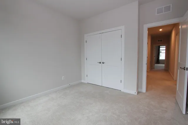 a large kitchen with stainless steel appliances a refrigerator a stove a sink dishwasher with a dining table and chairs