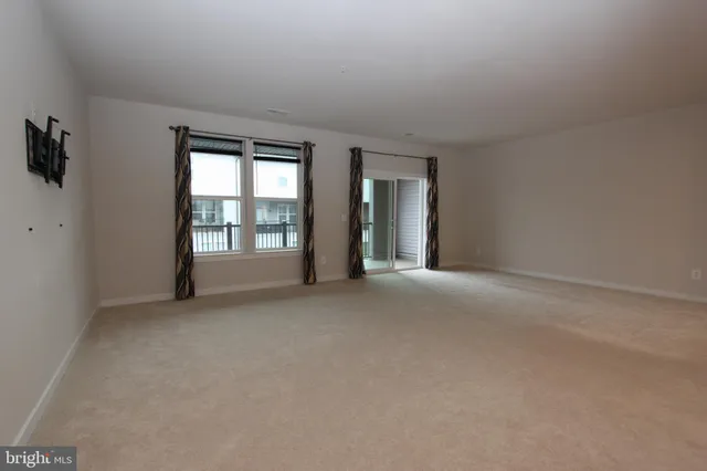 a view of a kitchen with a sink and a large window