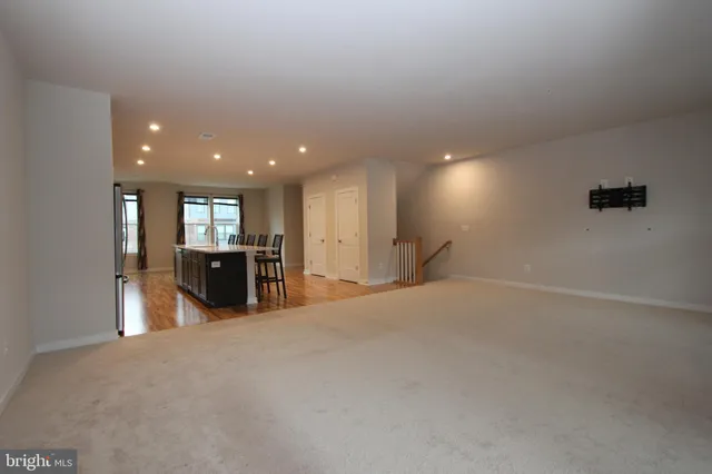 a view of a big room with windows and chandelier