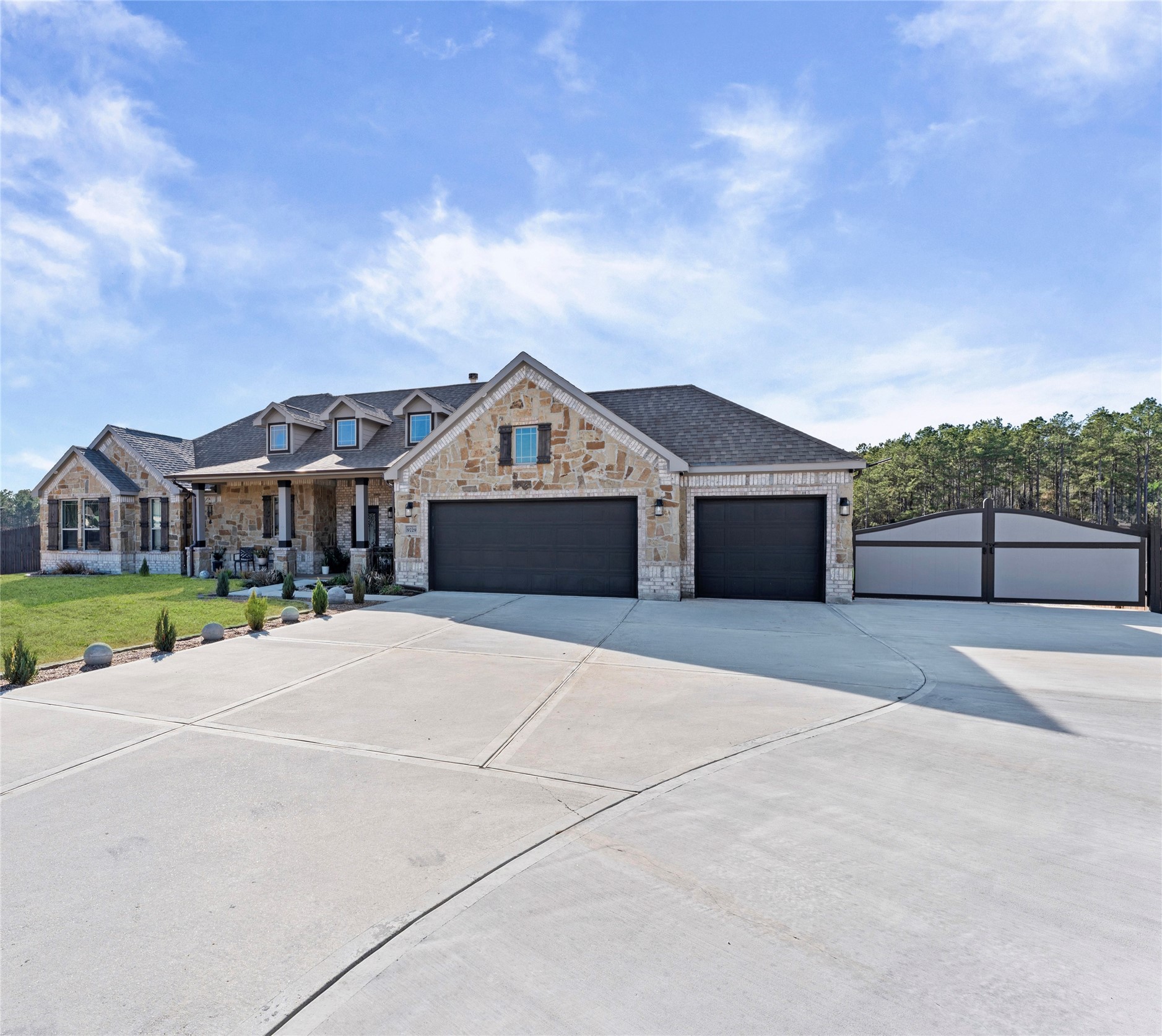 9729 Hidalgo Street Conroe, TX 77303 - Photo 4 of 38 Modern home with a three-car garage and a large expanded driveway with custom gate leading to large shop with office.