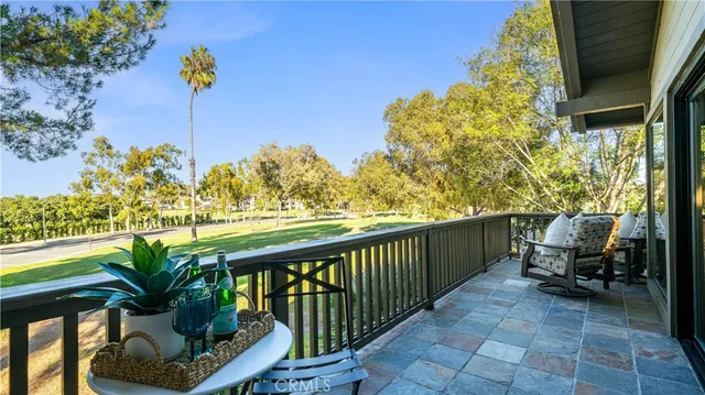 a view of a balcony with lake view and a potted plant