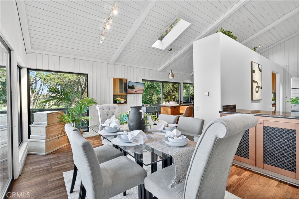30 Nuevo, Unit 15 Irvine, CA 92612 - Photo 20 of 69 a dining room with furniture a chandelier and wooden floor