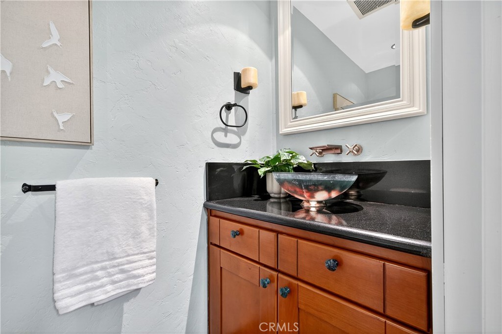 30 Nuevo, Unit 15 Irvine, CA 92612 - Photo 31 of 69 a kitchen with a sink and cabinets