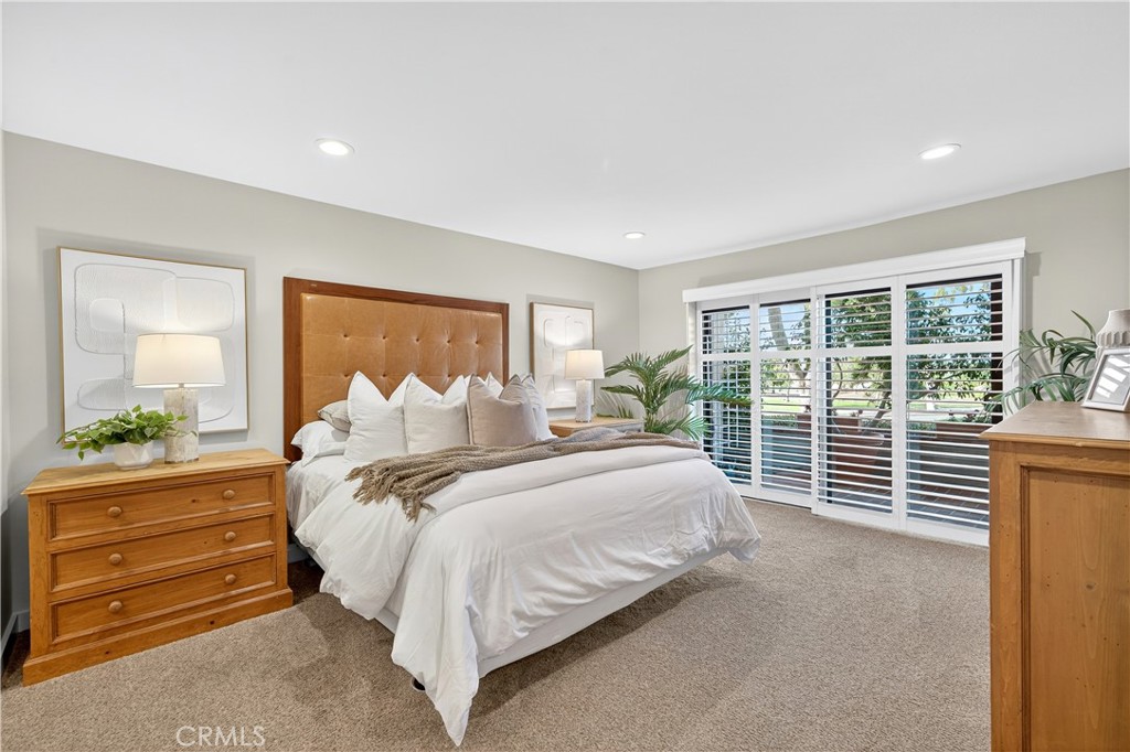 30 Nuevo, Unit 15 Irvine, CA 92612 - Photo 33 of 69 a bedroom with a large bed and a large window