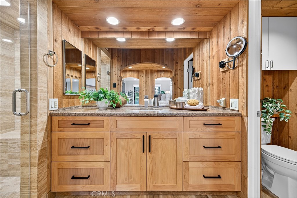 30 Nuevo, Unit 15 Irvine, CA 92612 - Photo 40 of 69 a bathroom with a granite countertop sink vanity mirror next to a window