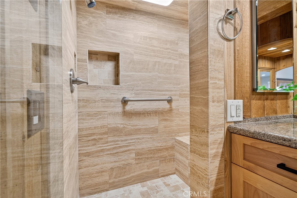 30 Nuevo, Unit 15 Irvine, CA 92612 - Photo 43 of 69 a bathroom with a granite countertop shower a mirror and a sink