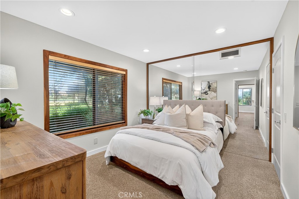 30 Nuevo, Unit 15 Irvine, CA 92612 - Photo 48 of 69 a bedroom with a large bed and a chandelier