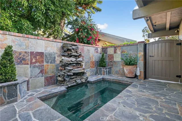 a view of a dining room with furniture a chandelier and wooden floor