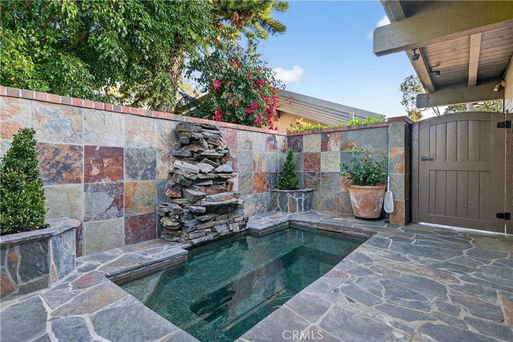 30 Nuevo, Unit 15 Irvine, CA 92612 - Photo 5 of 69 a view of a backyard with plants and a patio