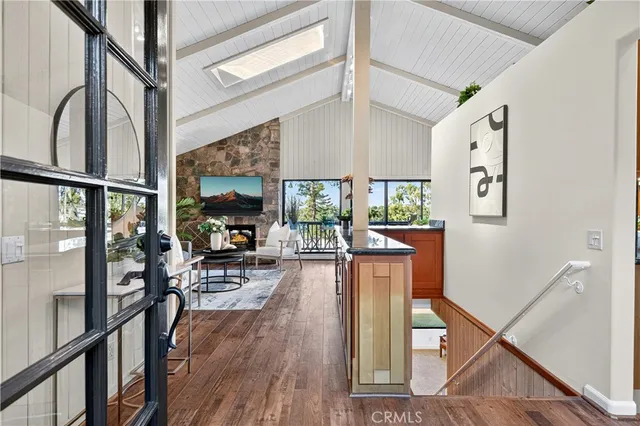 a living room with furniture a fireplace and a large window