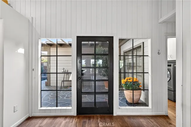 a living room with furniture a fireplace and a floor to ceiling window