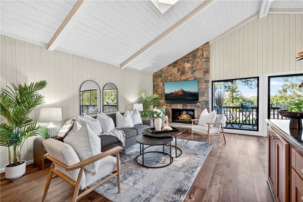 30 Nuevo, Unit 15 Irvine, CA 92612 - Photo 9 of 69 a living room with furniture a fireplace and a large window