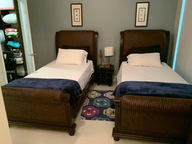 a bedroom with bed and dresser