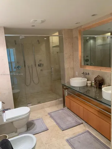 a bathroom with a glass shower door