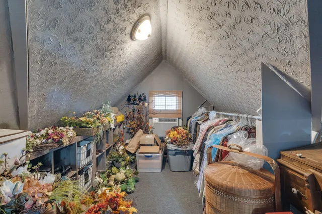 a living room with furniture and flowers