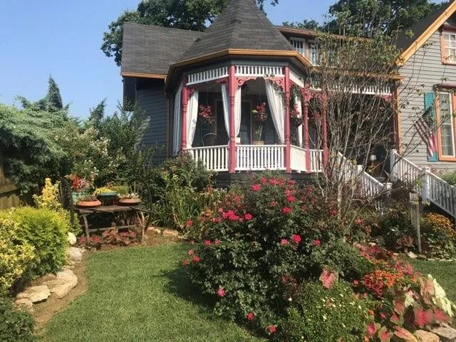 a front view of a house with a yard and garden