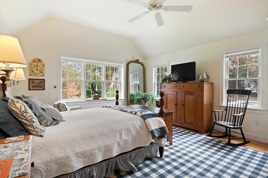 100 Round Cove Road Chatham, MA 02633 - Photo 16 of 38 a bedroom with a bed a flat screen tv and a couch