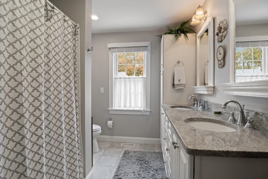 100 Round Cove Road Chatham, MA 02633 - Photo 17 of 38 a bathroom with a granite countertop sink and a mirror