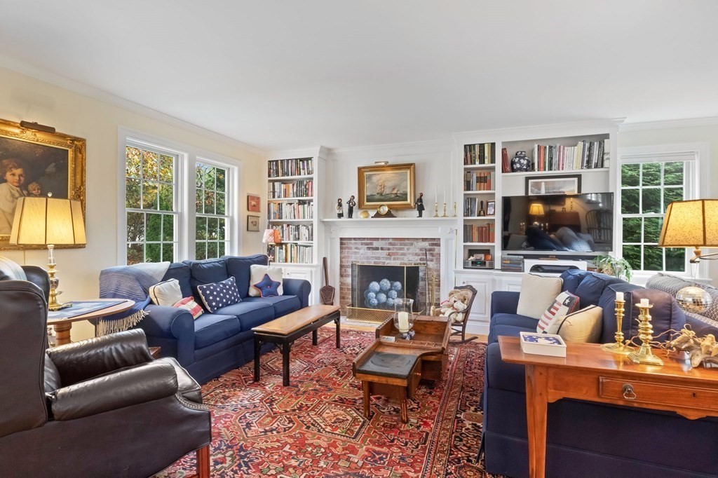 100 Round Cove Road Chatham, MA 02633 - Photo 2 of 38 a living room with furniture a flat screen tv and a fireplace