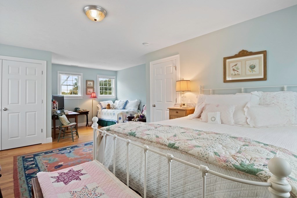100 Round Cove Road Chatham, MA 02633 - Photo 21 of 38 a bedroom with a bed and wooden floor