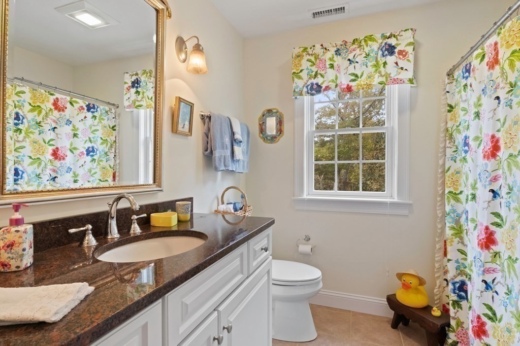 100 Round Cove Road Chatham, MA 02633 - Photo 22 of 38 a bathroom with a sink a mirror and a toilet