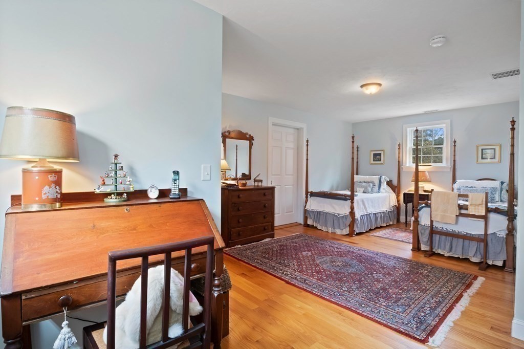 100 Round Cove Road Chatham, MA 02633 - Photo 23 of 38 a living room with furniture a rug and a lamp