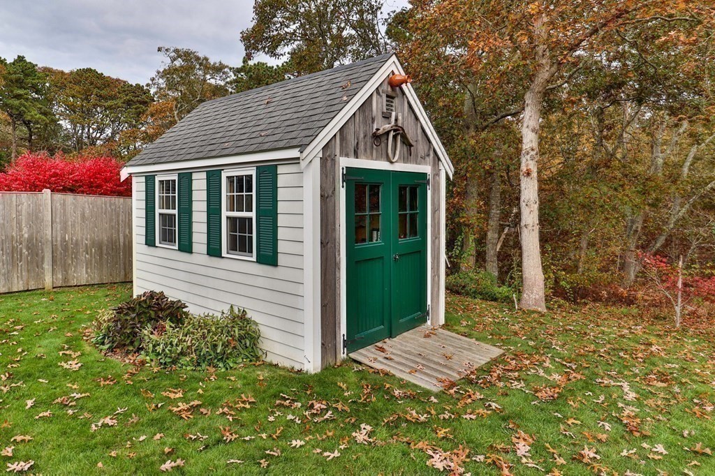 100 Round Cove Road Chatham, MA 02633 - Photo 28 of 38 a view of a house with a small yard and large tree