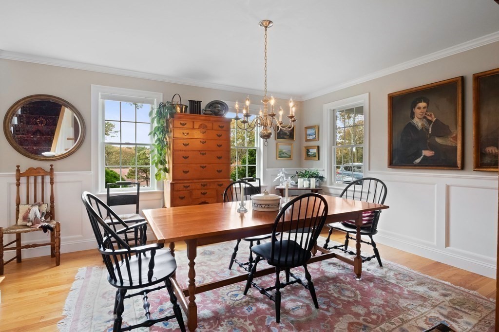 100 Round Cove Road Chatham, MA 02633 - Photo 5 of 38 a dining room with furniture a chandelier and wooden floor