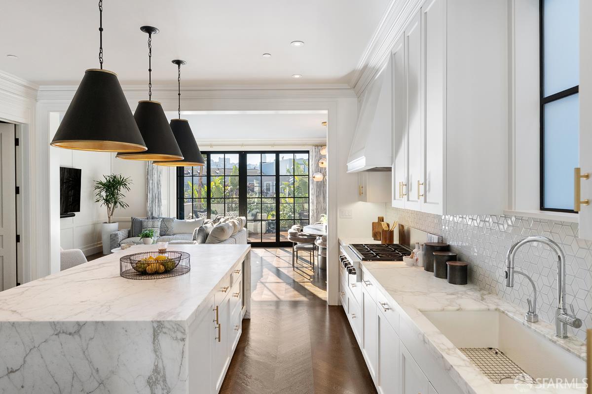 45 Capra Way San Francisco, CA 94123 - Photo 6 of 25 a kitchen with stainless steel appliances a counter space a sink a large window and cabinets