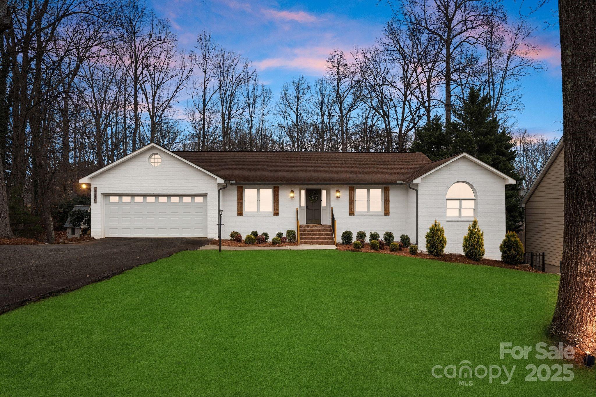 2550 Green Point Court Denver, NC 28037 - Photo 1 of 42 a front view of a house with a garden and trees