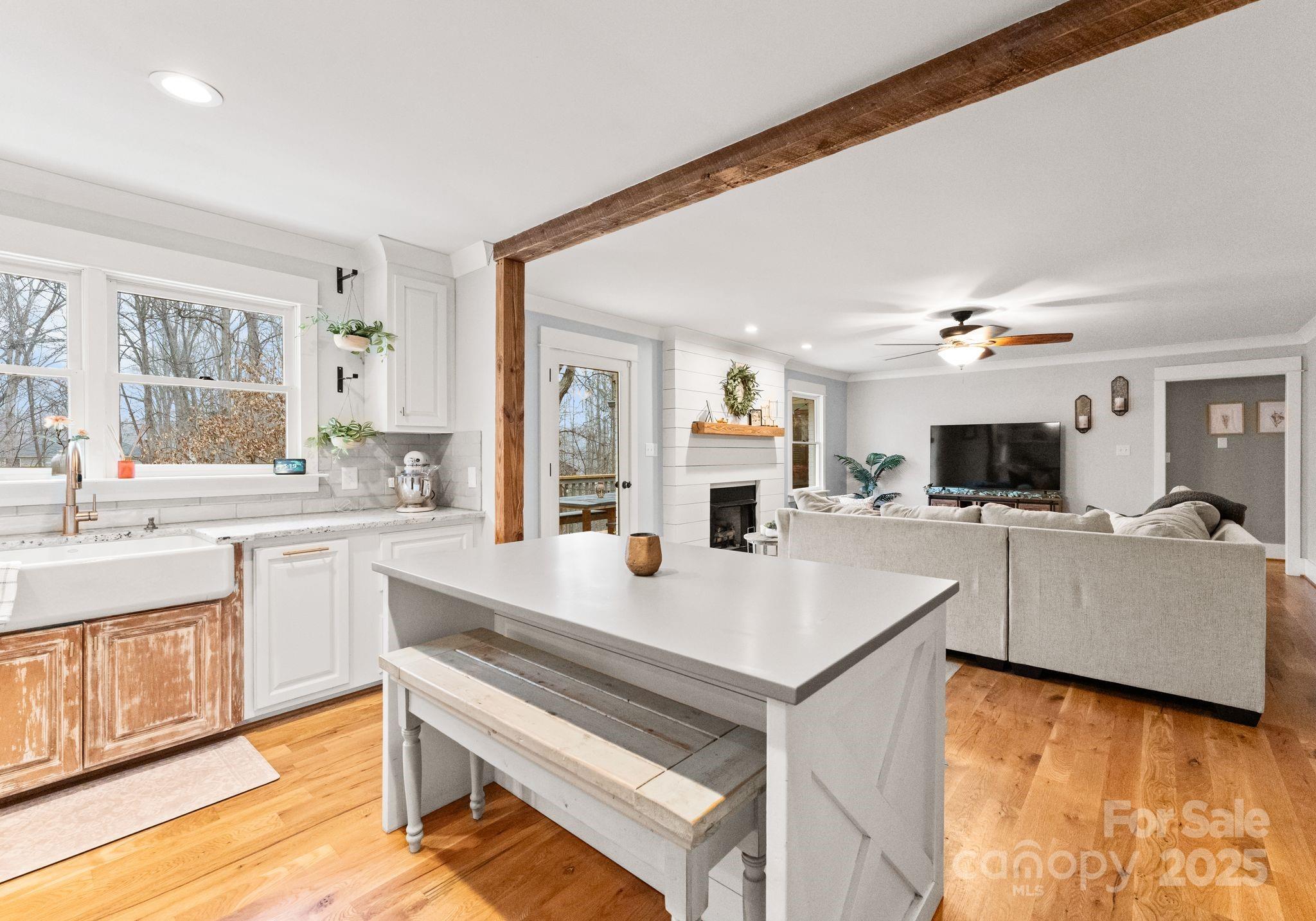 2550 Green Point Court Denver, NC 28037 - Photo 12 of 42 a open kitchen with a sink dishwasher a stove top oven a dining table and chairs with wooden floor