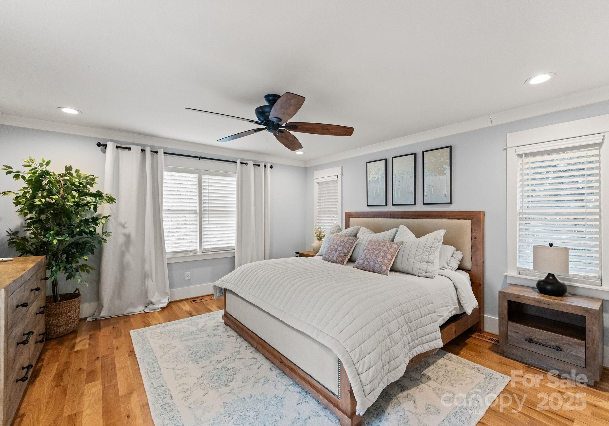 2550 Green Point Court Denver, NC 28037 - Photo 17 of 42 a bedroom with a large bed and a chandelier