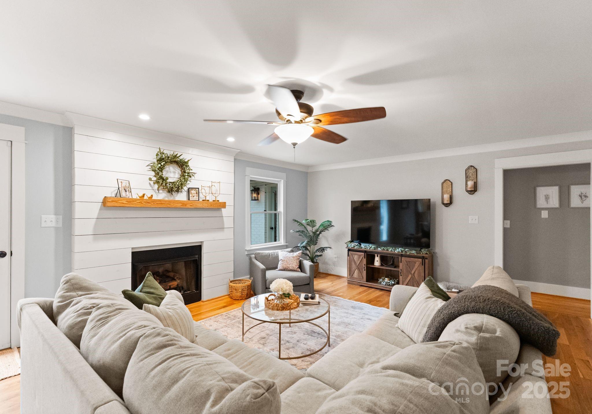 2550 Green Point Court Denver, NC 28037 - Photo 6 of 42 a living room with furniture a fireplace and a flat screen tv
