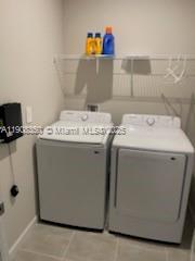 9509 Southwest Libertas Way, Unit : Port St. Lucie, FL 34987 - Photo 14 of 16 a utility room with dryer and washer