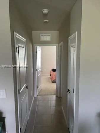 a view of a hallway view with three rooms