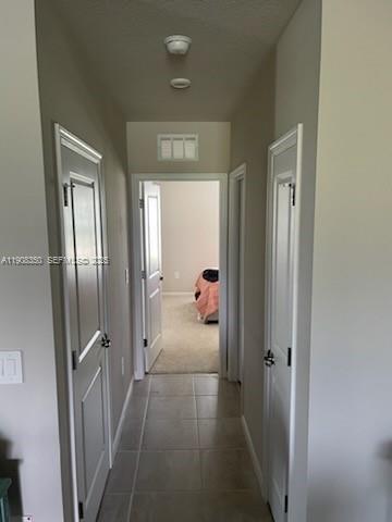 9509 Southwest Libertas Way, Unit : Port St. Lucie, FL 34987 - Photo 7 of 16 a view of a hallway view with three rooms