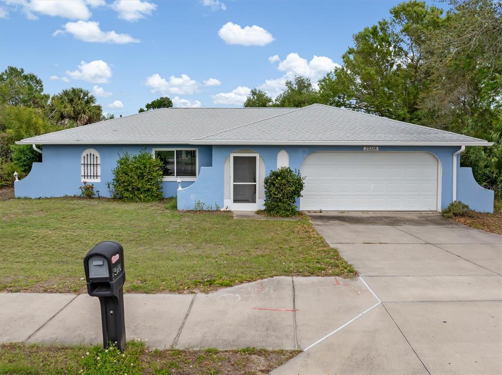 23226 Midway Boulevard Punta Gorda, FL 33980 - Photo 1 of 37 a front view of a house with garden