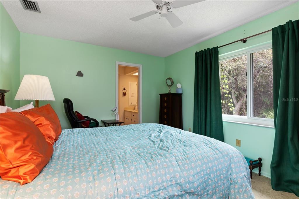 23226 Midway Boulevard Punta Gorda, FL 33980 - Photo 14 of 37 a bedroom with a large bed and a window