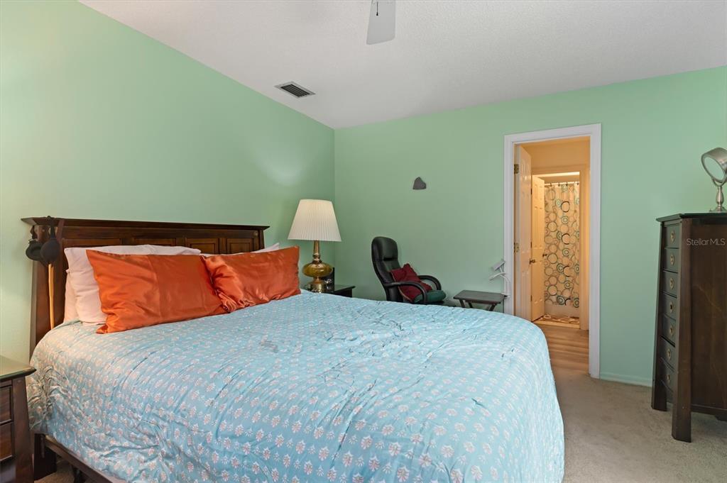 23226 Midway Boulevard Punta Gorda, FL 33980 - Photo 15 of 37 a bed sitting in a bedroom next to a window