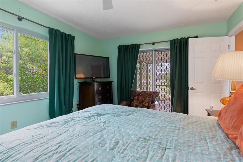 23226 Midway Boulevard Punta Gorda, FL 33980 - Photo 17 of 37 a bedroom with a bed and a flat tv screen in it