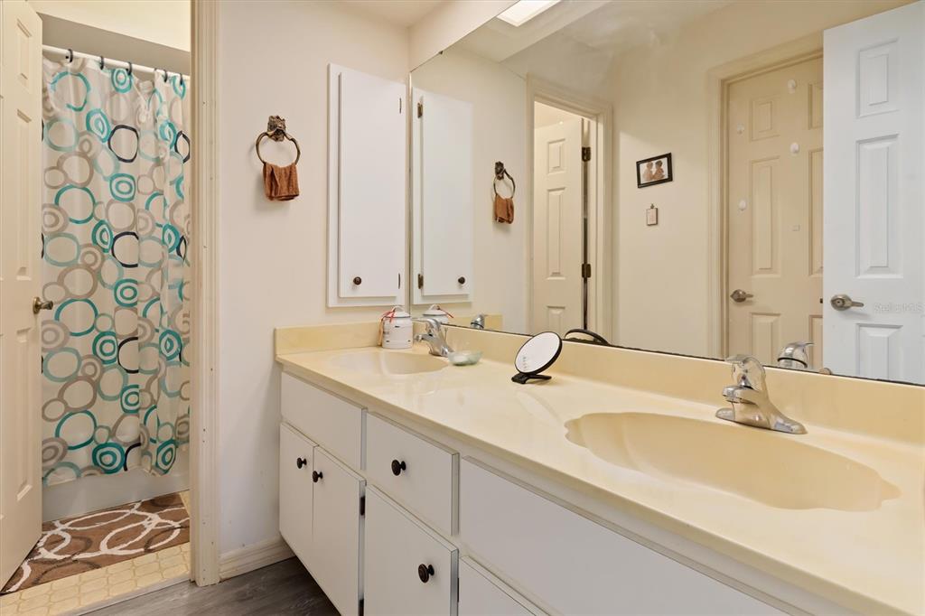 23226 Midway Boulevard Punta Gorda, FL 33980 - Photo 18 of 37 a bathroom with a granite countertop sink and a mirror