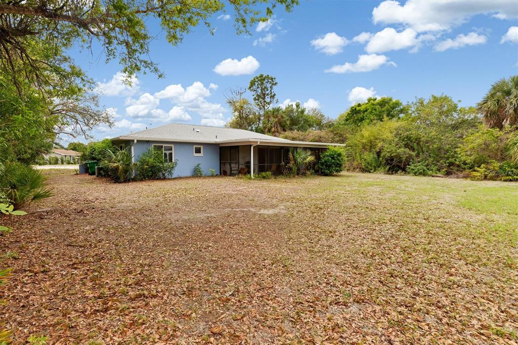 23226 Midway Boulevard Punta Gorda, FL 33980 - Photo 24 of 37 a view of a house with a yard and potted plants