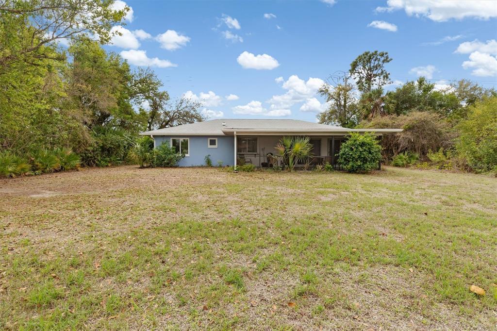 23226 Midway Boulevard Punta Gorda, FL 33980 - Photo 25 of 37 a view of a house with a yard and potted plants