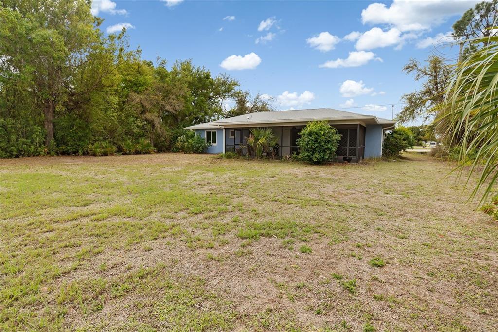 23226 Midway Boulevard Punta Gorda, FL 33980 - Photo 26 of 37 a view of a house with a yard and garage