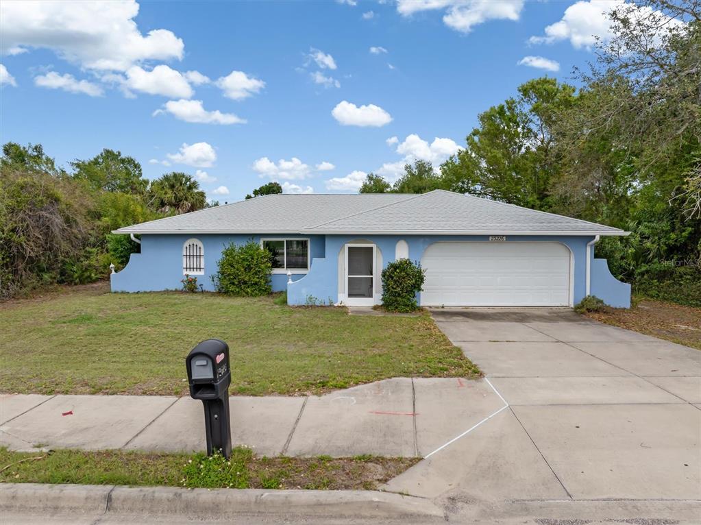 23226 Midway Boulevard Punta Gorda, FL 33980 - Photo 30 of 37 a front view of a house with garden